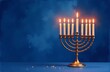 © Olga - Menorah with burning candles on dark blue background.  Hanukkiah - symbol of jewish holiday Hanukkah. Christmas religious holiday greeting card with copy space. Template banner Watercolor illustration