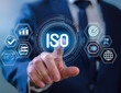 © Abul - The notion of standard quality control certification assurance. An entrepreneur is interacting with ISO certification icons on a virtual screen. Standards, guarantees, and quality assurance