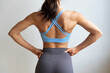 © 9nong - Closeup rear view of strong fit healthy Asian woman with strong muscle and lean body, flexing her back shoulder muscle, concept for fitness gym, sport woman, body building, strong and healthy