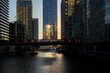 © yaqui_villegas - A cityscape view at sunset with golden reflections dancing on water bodies surrounded by towering skyscrapers, creating a tranquil yet vibrant urban environment in London UK