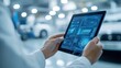 © Ti Studio - Auto mechanic reviewing car data on tablet, isolated on white, representing high-tech automotive repair