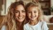 © JoxyAimages - A joyful portrait of a mother and her young daughter smiling brightly, showcasing a bond of love and happiness, captured in a warm and inviting home setting.