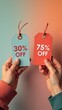 © Magrelos - Hands hold discount tags for 30% and 75% off against a vibrant background