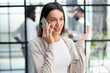 © Katsiaryna - Businesswoman with phone in modern office