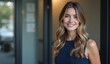 © Yury - Smiling woman with wavy blonde hair confidently posing in office setting