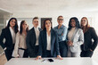 © Flamingo Images - Confident group of diverse businesswoman standing in an office boardroom