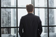 © Katsiaryna - Rear view portrait of a businessman standing in the office