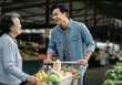 © Alexandra - Asian family purchasing fresh produce, enjoying time together at outdoor market