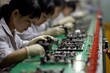 © AiHRG Design - A group of Asian individuals diligently assembles electronic components on a production line. They wear gloves and focus on their tasks, emphasizing teamwork and precision in their work.