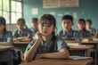 © AiHRG Design - In a classroom setting, diverse young Asian students focus on their lessons while seated at desks. They appear attentive and eager to learn, with notebooks and pens in front of them.