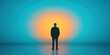 © kiimoshi - A silhouette of a man standing alone against a vibrant sunset, evoking contemplation.