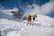 © Halfpoint - Young family is enjoying winter holiday in the mountains, playing and walking through the snowy landscape.