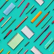 © vadosloginov - A vibrant collection of high school supplies organized on a colorful teal background showcasing pens and notebooks