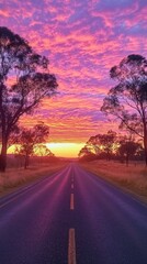 Poster - A captivating sunset illuminating a quiet road flanked by trees, showcasing vibrant colors and peaceful solitude