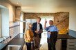 © Marko Geber - Elderly couple consulting with real estate agent in new home kitchen