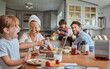 © Geber86 - Happy family enjoying breakfast together in kitchen