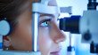 © Iryna Matukhno - A young woman undergoing an eye examination using a slit lamp in a modern optometry clinic during daylight hours