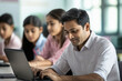 © Neha - A male Indian teacher helping students in the computer lab, with happy and smiling expressions of the children using computers.