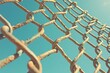 © faiz - Rustic Chain Link Fence Against Clear Blue Sky Backdrop