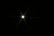© Connect Images - Bright starburst light effect with colorful diffraction streaks on a black background.