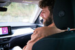 © Connect Images - Man with a beard is passenger in a car, looking at the road ahead, with the interior and dashboard clearly visible.