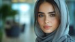 © julija - serious young arab woman in hijab passionately discussing a project with her colleague in a modern office space, emphasizing teamwork and professionalism in a collaborative environment