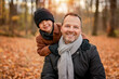 © Louis-Photo - Joyful dad and his child boy. daddy and child have fun, laugh and enjoy nature outdoors at autumn park.