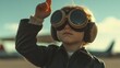 © VK Studio - A young child in an aviator jacket and goggles raises an arm to the sky, dreaming of adventures and open horizons.