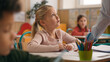 © Yuliia - Caucasian woman teacher in elementary school teach children class kids writing task in classroom knowledge studying primary education lesson female tutor teaching learning boys girl study pupils learn
