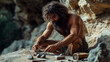 © ksu_ok - A primitive man focuses intently on crafting stone tools in a cave, showcasing survival, ancient skills, and the resourcefulness of early humans in the wild.