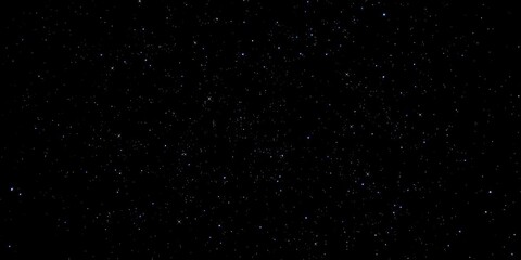 Wall Mural - close-up view of sparkling stars scattered across the velvet blackness of night sky with some stars 