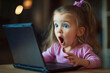 © Di Studio - shocked little girl looking at laptop at home