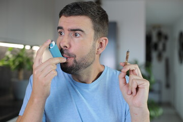 Asthmatic man smoking and using an inhaler 