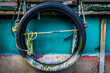 © LoweStock - Tire used as a fender on old fishing boat makes for an interesting abstract design. Shapes, colors and textures work well together to intimate industrial elements and design.