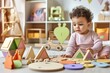 © ERiK - A toddler plays with wooden toys while sitting on the floor in his kindergarten playroom, surrounded by colorful wooden pieces and puzzles.