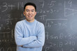 © fotolite - A student stands confidently in front of a blackboard with math