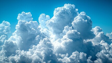 Wall Mural - A vibrant sky filled with fluffy white clouds against a bright blue backdrop.