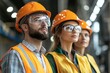© YouraPechkin - Safety professionals in protective gear observe industrial operations in a large facility
