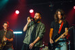 © Zamrznuti tonovi - Rock band performing live on stage with saxophone, guitar and vocals