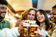 © charmedlightph - Group of smiling people cheering and drinking beer at bar pub table - Happy young friends enjoying happy hour at brewery restaurant - Life style concept about youth culture, home food and beverage