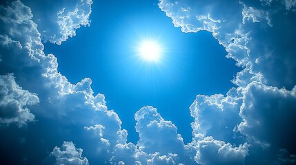 Wall Mural - Bright sun shining through fluffy clouds in a clear blue sky.