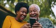 © RealPeopleStudio - Senior couple learning to use a smartphone, both laughing