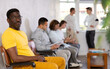 © JackF - Portrait of an african american man sitting in a chair in the lobby waiting