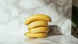 © Monchisa - Ripe Bananas on Marble Countertop, vibrant yellow bananas arranged neatly on a polished white marble surface, emphasizing their smooth texture and freshness