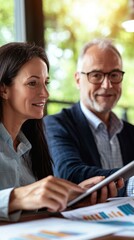 Wall Mural - A man and woman look at a tablet while discussing business. AI.