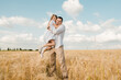 © sharshonm - Happy child and dad hugging in a rye field.