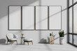 © EliteStock - A modern, minimalist living space featuring two stylish chairs, a small table, and four empty frames on a sunlit wall.
