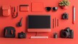 © Sumet - Vibrant Red Workspace Setup Featuring Various Office Supplies, Technology Tools, and Creative Accessories for Modern Professionals and Creatives