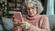 © Natalia S. - An older woman transfers money to phone scammers. Cybercrime and the vulnerable, gullible pensioners lose money