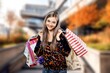 © BillionPhotos.com - Happy relaxed young woman walking with shopping bags